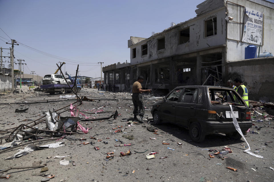 Afghan security personnel inspect at the site of a suicide attack in Kabul, Afghanistan, Thursday, July 25, 2019. Three bombings struck the Afghan capital on Thursday, killing at least eight people, including five women and one child, officials said Thursday. (AP Photo/Rahmat Gul)