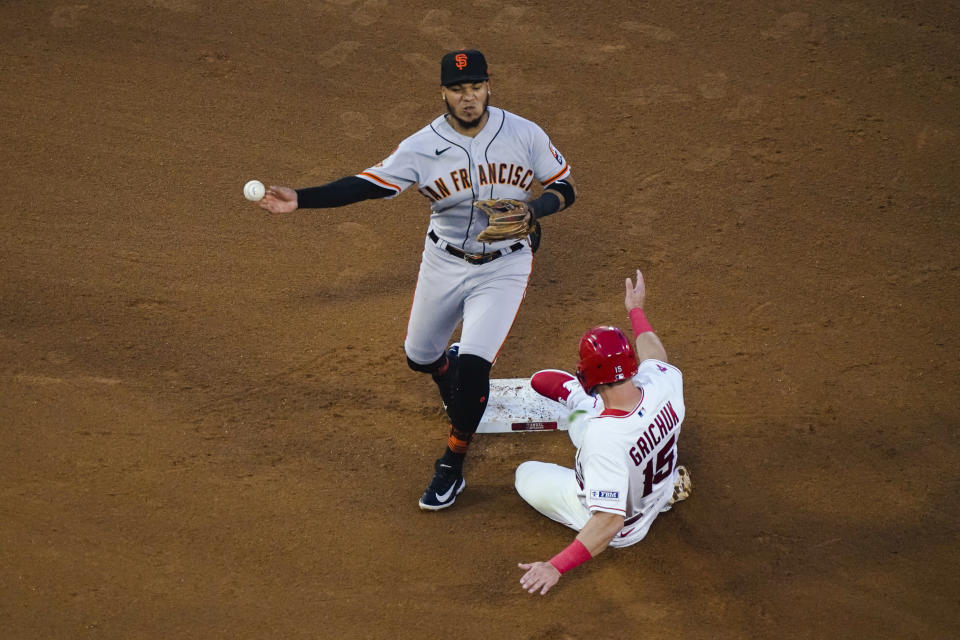 San Francisco Giants second baseman Thairo Estrada throws to first after forcing out Randal Grichuk (15) on a ball hit by Luis Rengifo, who was safe, during the third inning of a baseball game Wednesday, Aug. 9, 2023, in Anaheim, Calif. (AP Photo/Ryan Sun)