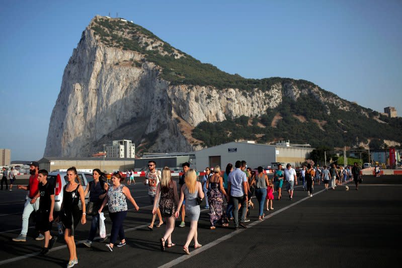 Pedestrians cross the tarmac at Gibraltar International Airport in front of the Rock near the border with Spain in the British overseas territory of Gibraltar, historically claimed by Spain, June 24, 2016. REUTERS/Jon Nazca