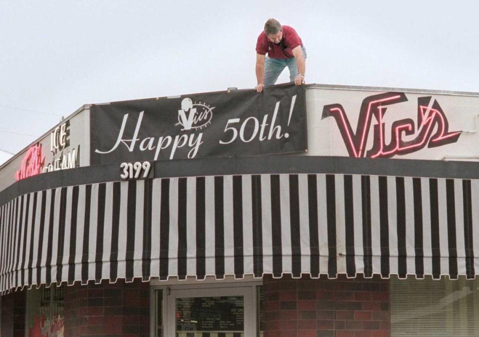 Vic’s Ice Cream owner Craig Rutledge puts up 50th Anniversary banner on the front of establishment at 3199 Riverside Blvd. Rutledge, who operated the ice cream parlor for 40 years, died Monday at the age of 73. Owen Brewer/Sacramento Bee file