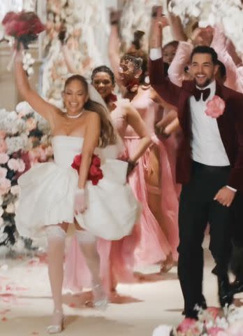 <p>jennifer lopez/ Instagram</p> Jennifer Lopez wears a bridal minidress in the "Can't Get Enough" music video