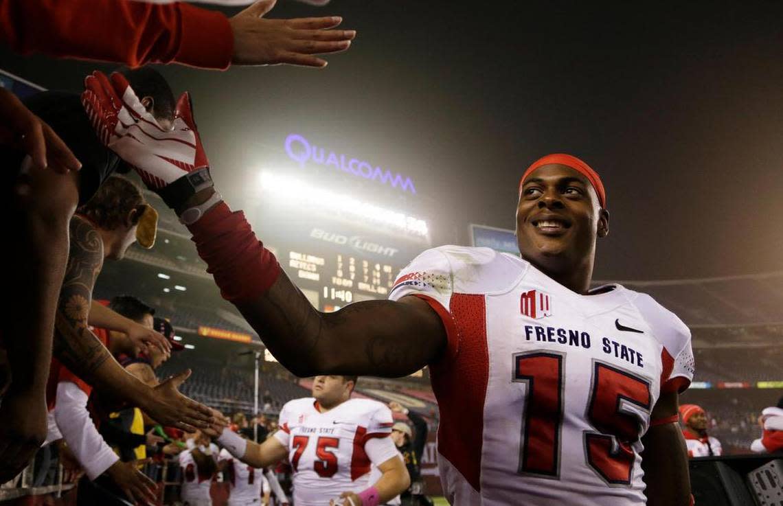 Former Fresno State wide receiver Davante Adams, right, is greeted by fans after a victory at San Diego State in 2013.