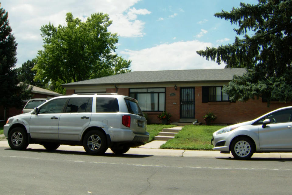 Cars parked outside the home where a man fired a gun at police, in Englewood, Colo. (KUSA)