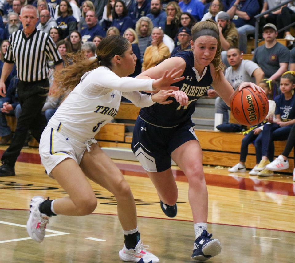 Fairfield's Morgan Gawthrop (14) drives against Highland's Bree Flores (3) during the IHSAA Regional Finals Saturday, Feb. 11, 2023 at Jimtown High School.