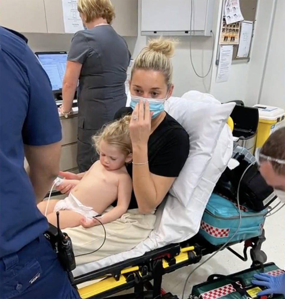 Karl's wife holding their daughter Harper while in the hospital