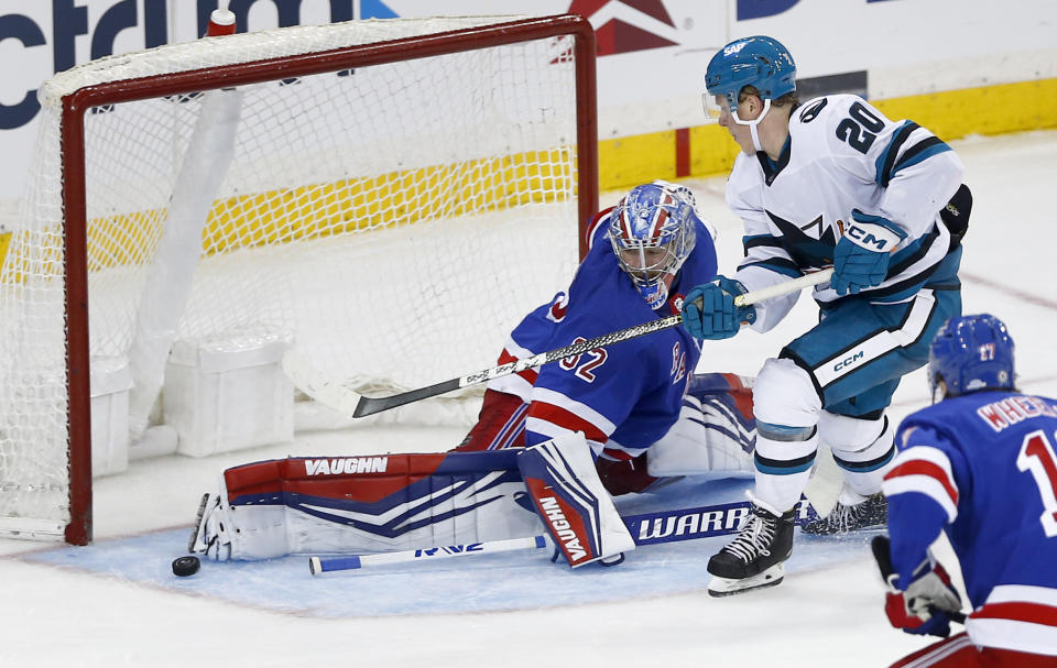 New York Rangers goalie Jonathan Quick (32) makes a save against San Jose Sharks forward Fabian Zetterlund (20) during the third period of an NHL hockey game Sunday, Dec. 3, 2023, in New York. (AP Photo/John Munson)