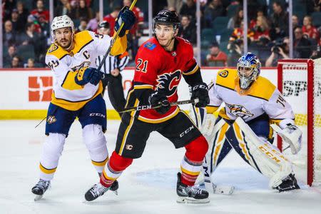 Dec 8, 2018; Calgary, Alberta, CAN; Calgary Flames right wing Garnet Hathaway (21) and Nashville Predators defenseman Roman Josi (59) fight for position in front of Nashville Predators goaltender Juuse Saros (74) during the third period at Scotiabank Saddledome. Calgary Flames won 5-2. Sergei Belski-USA TODAY Sports