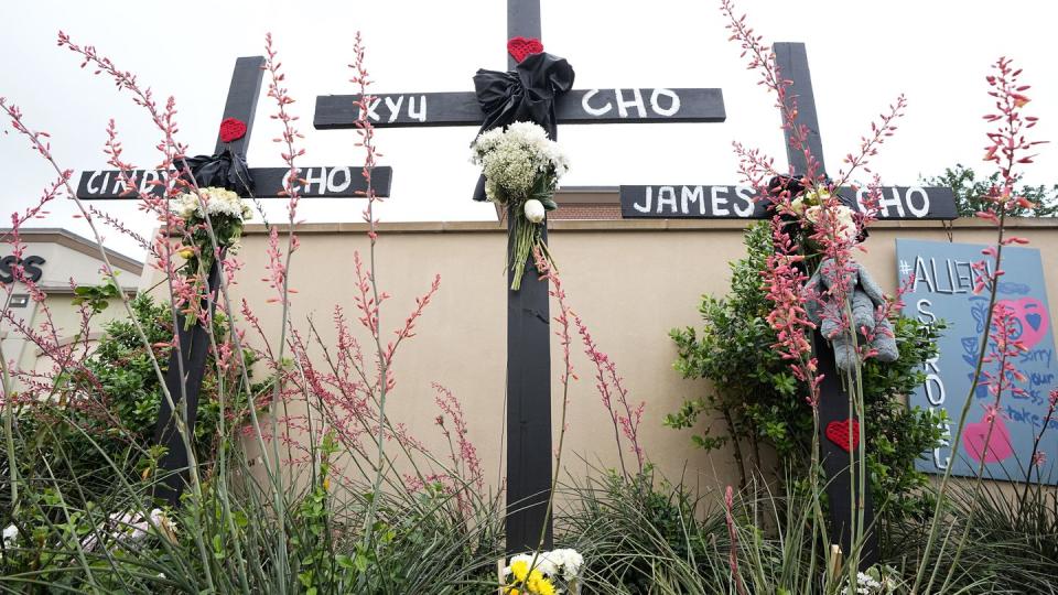 Crosses with the names, Cindy Cho, Kyu Cho and James Cho stand at a makeshift memorial beside the mall in Allen, Texas, where the Chos and several other people were killed, Wednesday, May 10, 2023.