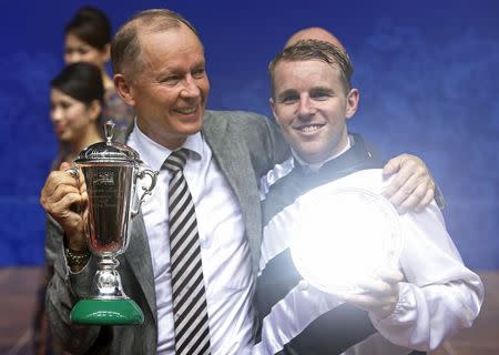 Australian jockey Tommy Berry of Dan Excel and his trainer and compatriot John Moore celebrates after winning the Singapore Airlines International Cup horse race at the Singapore Turf Club May 17, 2015. REUTERS/Edgar Su