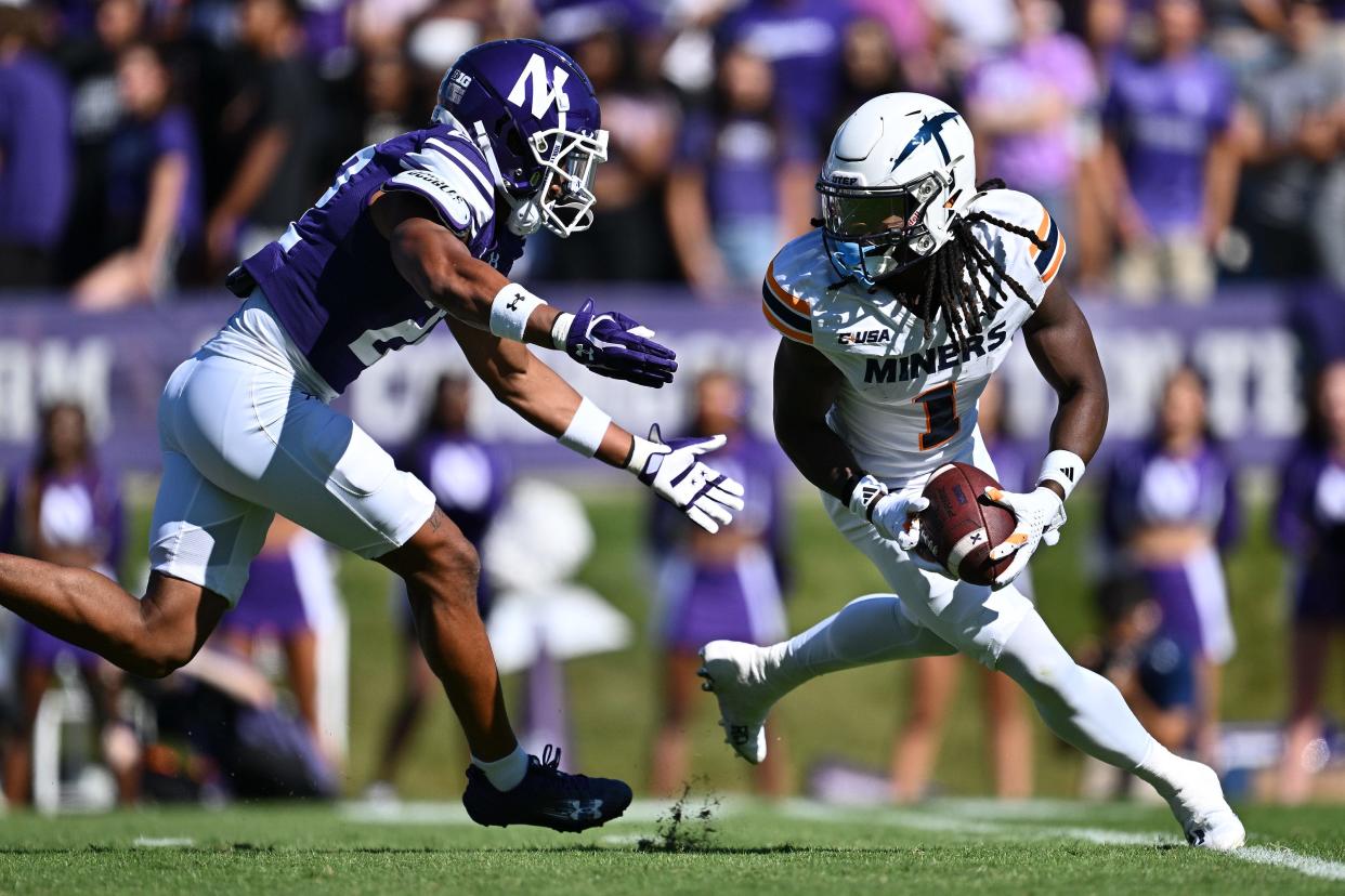 University of Texas El Paso Miners wide receiver Tyrin Smith (1) looks for running room after fielding a punt as Northwestern Wildcats defensive back Evan Smith (22) closes in back in September. Smith is now a UC Bearcat.