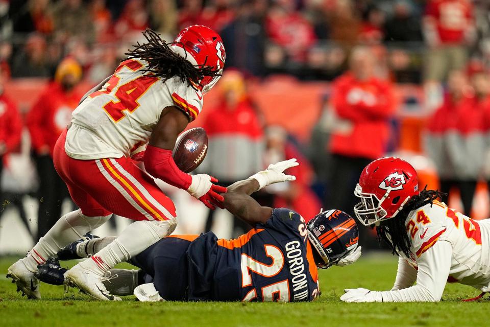 Denver's Melvin Gordon loses a fumble caused by Melvin Ingram (right) before Nick Bolton scooped it up and returned it for a touchdown.