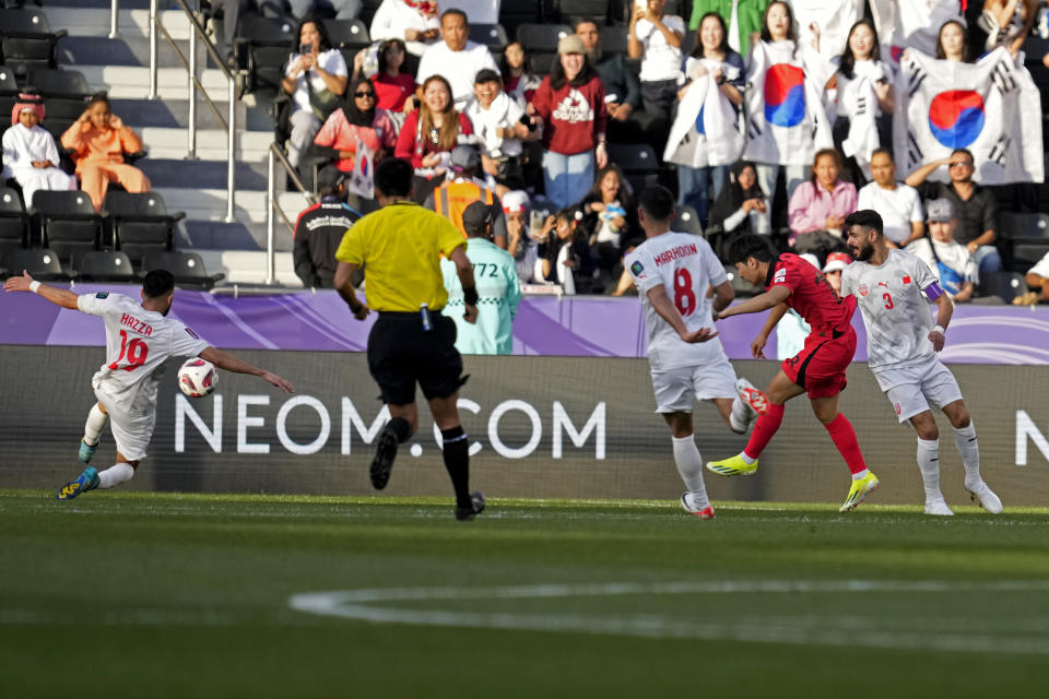 South Korea's Lee Kang-in, second right, shoots to score his side's third goal during the Asian Cup Group E soccer match between South Korea and Bahrain at Jassim Bin Hamad Stadium in Doha, Qatar, Monday, Jan. 15, 2024. (AP Photo/Thanassis Stavrakis)