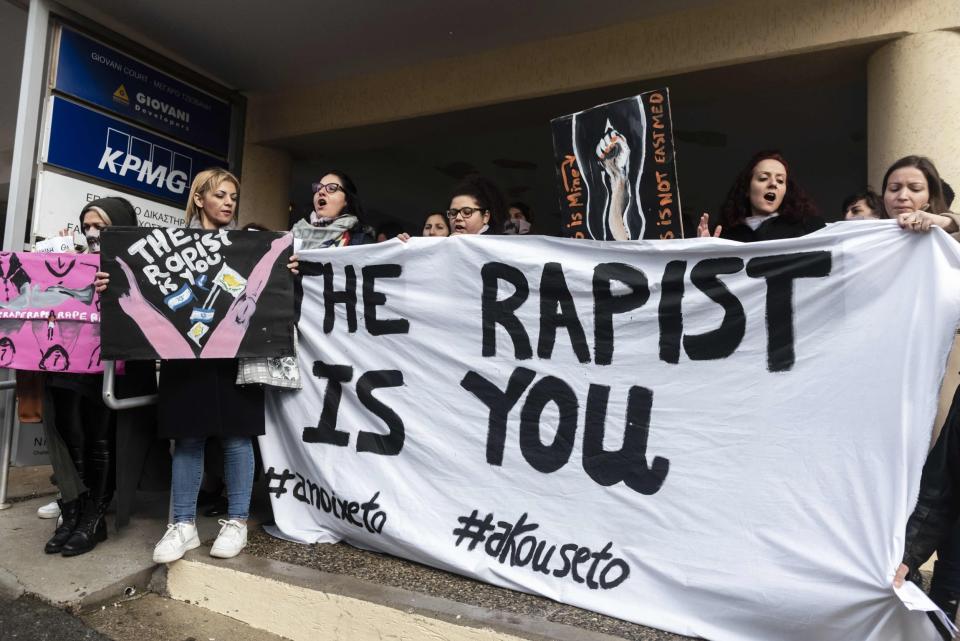 Activists outside court after a British woman was found guilty of faking a gang rape claim (AFP via Getty Images)