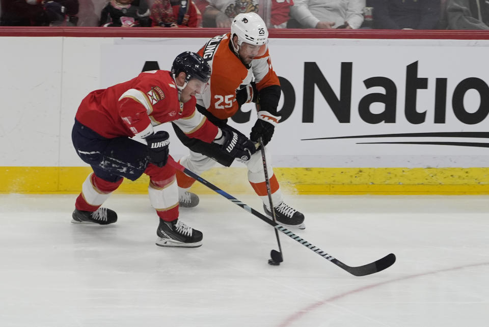 Florida Panthers defenseman Dmitry Kulikov (7) and Philadelphia Flyers center Ryan Poehling (25) go after the puck during the first period of an NHL hockey game, Tuesday, Feb. 6, 2024, in Sunrise, Fla. (AP Photo/Marta Lavandier)