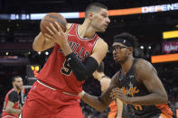 Chicago Bulls center Nikola Vucevic (9) sets up for a shot in front of Orlando Magic center Wendell Carter Jr. (34) during the first half of an NBA basketball game, Friday, Nov. 26, 2021, in Orlando, Fla. (AP Photo/Phelan M. Ebenhack)