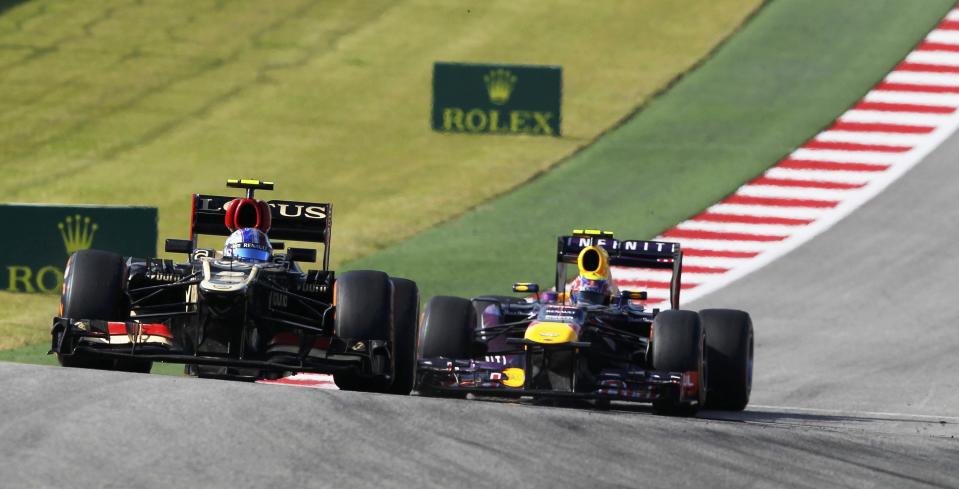 Lotus F1 Formula One driver Romain Grosjean of France (L) leads Red Bull Formula One driver Mark Webber of Australia through a turn during the U.S. F1 Grand Prix at the Circuit of the Americas in Austin, Texas November 17, 2013.