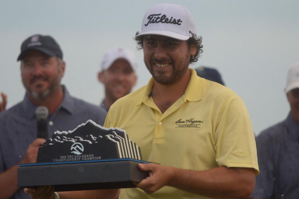 Nelson Ledesma holds the trophy after hitting a birdie putt on hole No. 18 to win the inaugural TPC Colorado Championship at Heron Lakes in Berthoud in 2019.