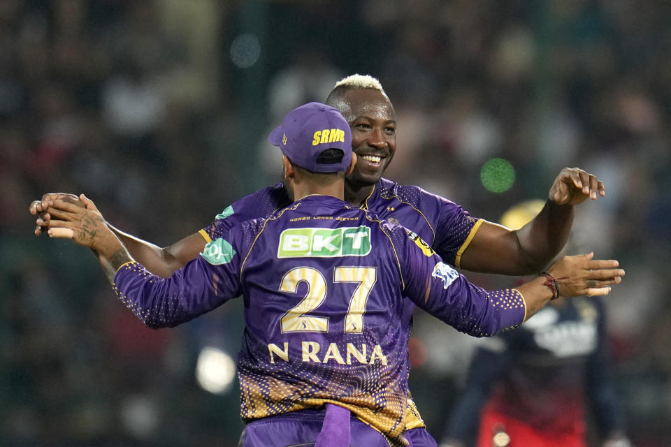 Kolkata Knight Riders' Andre Russell, right, celebrates with captain Nitish Rana after the dismissal of Royal Challengers Bangalore's Wanindu Hasaranga during the Indian Premier League cricket match between Royal Challengers Bangalore and Kolkata Knight Riders in Bengaluru, India, Wednesday, April 26, 2023. (AP Photo/Aijaz Rahi)