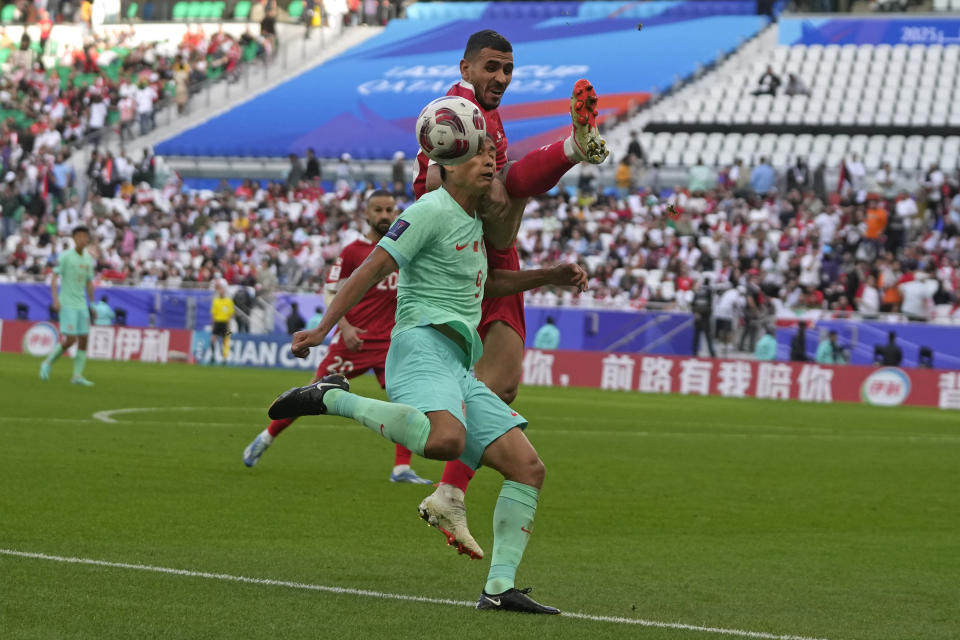 Lebanon's Kassem El Zein, right, is challenged by China's Zhang Tun during the Asian Cup Group A soccer match between China and Lebanon at Al Thumama Stadium in Doha, Qatar, Wednesday, Jan. 17, 2024. (AP Photo/Thanassis Stavrakis)