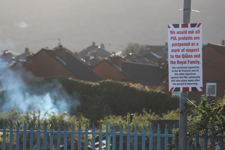 A sign on the corner of the Shankill Road and Lanark Way in Belfast calling for the postponement of protestsPA