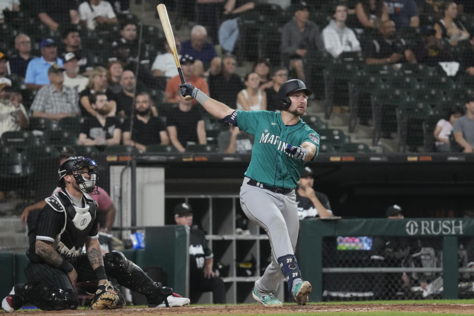 Seattle Mariners' Cal Raleigh, right, watches his three-run home run during the eighth inning Monday against the Chicago White Sox. The Mariners won 14-2. (AP Photo/Nam Y. Huh)