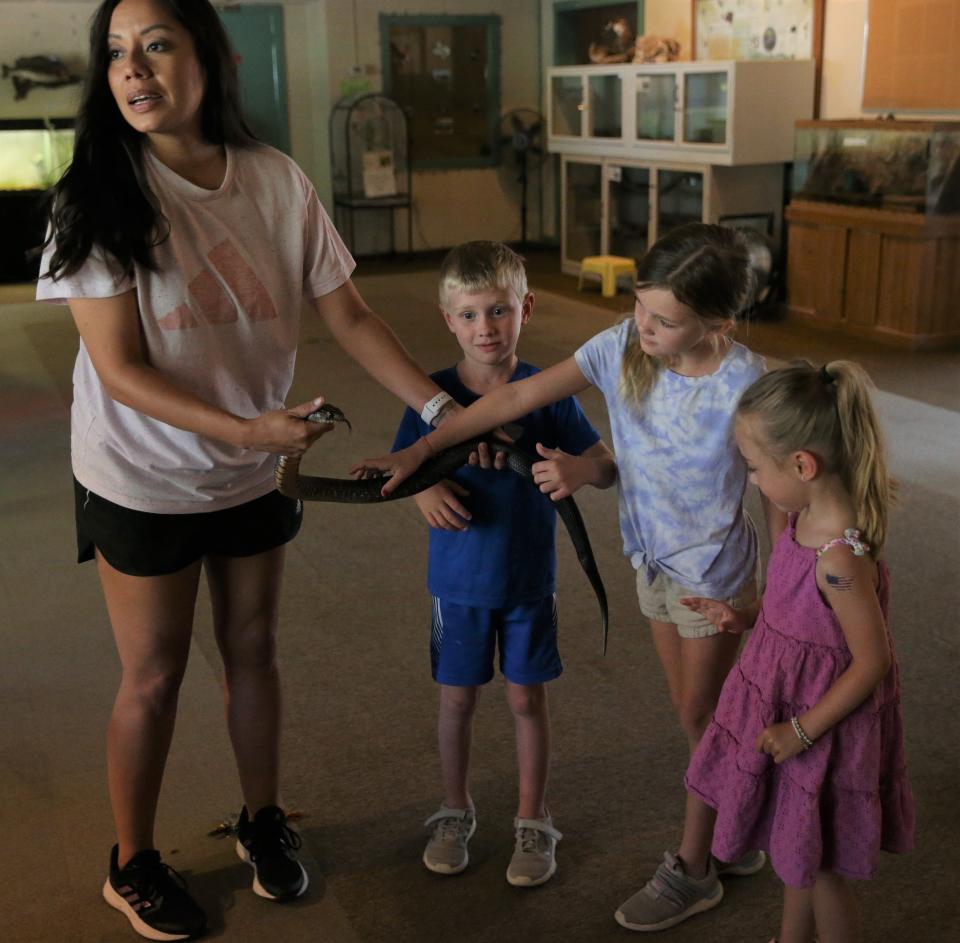 Selina McSherry with the San Angelo Nature Center lets some children touch one of the many different snakes that the facility has in its exhibits.