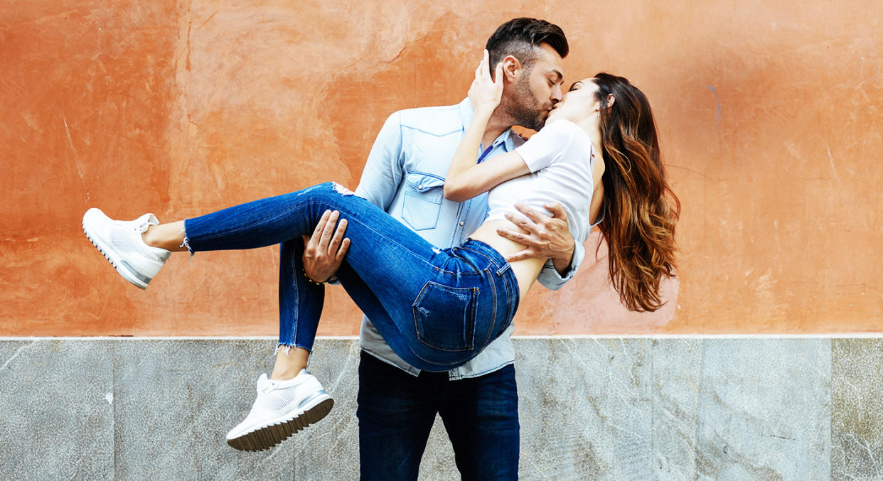 Couple kissing outside. (Getty Images)