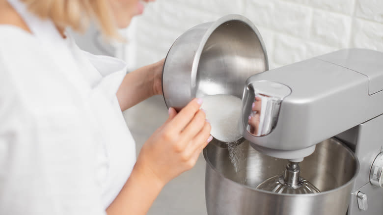 Pouring sugar into mixing bowl