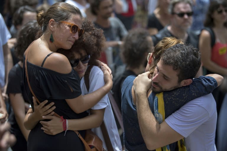 Mourners comfort each other during the funeral of slain Brazilian councilwoman and activist Marielle Franco in Rio de Janeiro