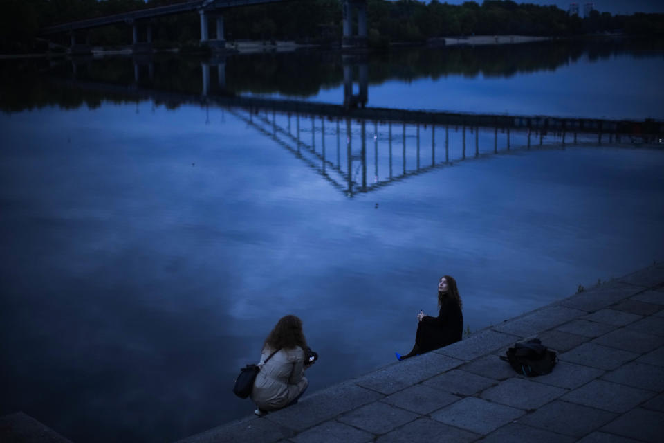 A woman poses for a photo session at the Dnipro riverbank in Kyiv, Ukraine, Saturday, Oct. 1, 2022. (AP Photo/Francisco Seco)