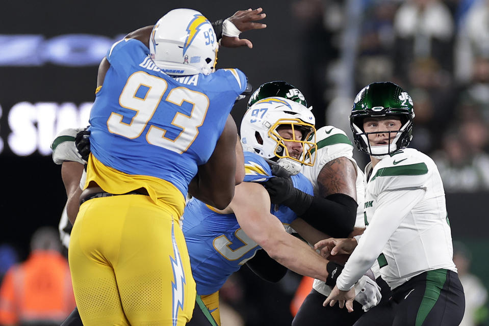 Los Angeles Chargers linebacker Joey Bosa (97) strips the ball from New York Jets quarterback Zach Wilson (2) during the first quarter of an NFL football game, Monday, Nov. 6, 2023, in East Rutherford, N.J. (AP Photo/Adam Hunger)