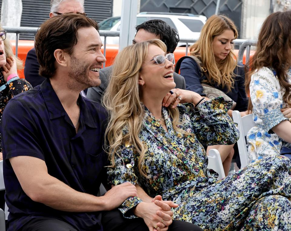 Actors Tom Pelphrey and Kaley Cuoco hold hands as "Flight Attendant" executive producer Greg Berlanti receives a star on the Hollywood Walk of Fame on May 23, 2022.