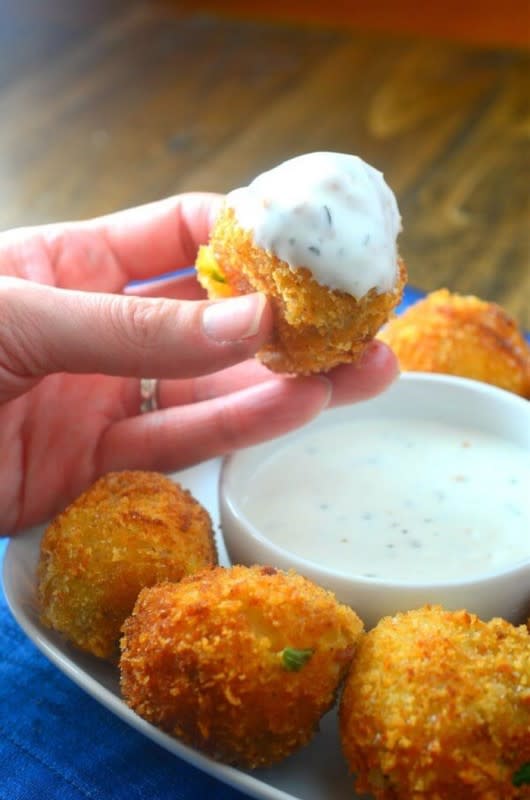 <p>Oh Sweet Basil</p><p><strong>Recipe: <a href="https://ohsweetbasil.com/cheesy-loaded-potato-bombs-recipe/" rel="nofollow noopener" target="_blank" data-ylk="slk:Cheesy Loaded Potato Bombs;elm:context_link;itc:0;sec:content-canvas" class="link ">Cheesy Loaded Potato Bombs</a></strong></p>