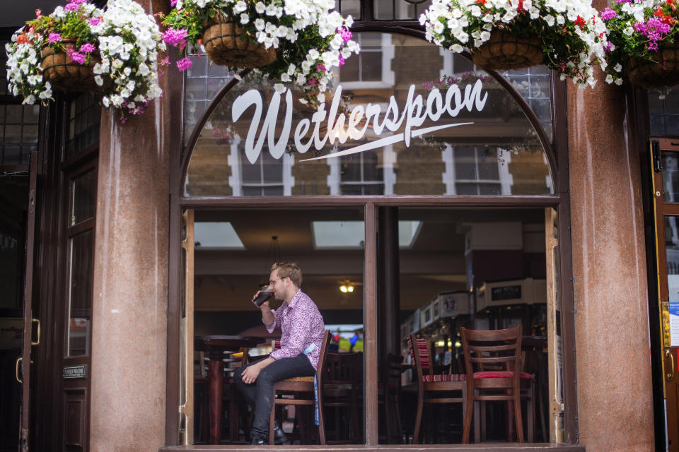 One of the first drinkers at the reopening of the Rochester Castle pub in Stoke Newington, North London, as coronavirus lockdown restrictions are eased across England.