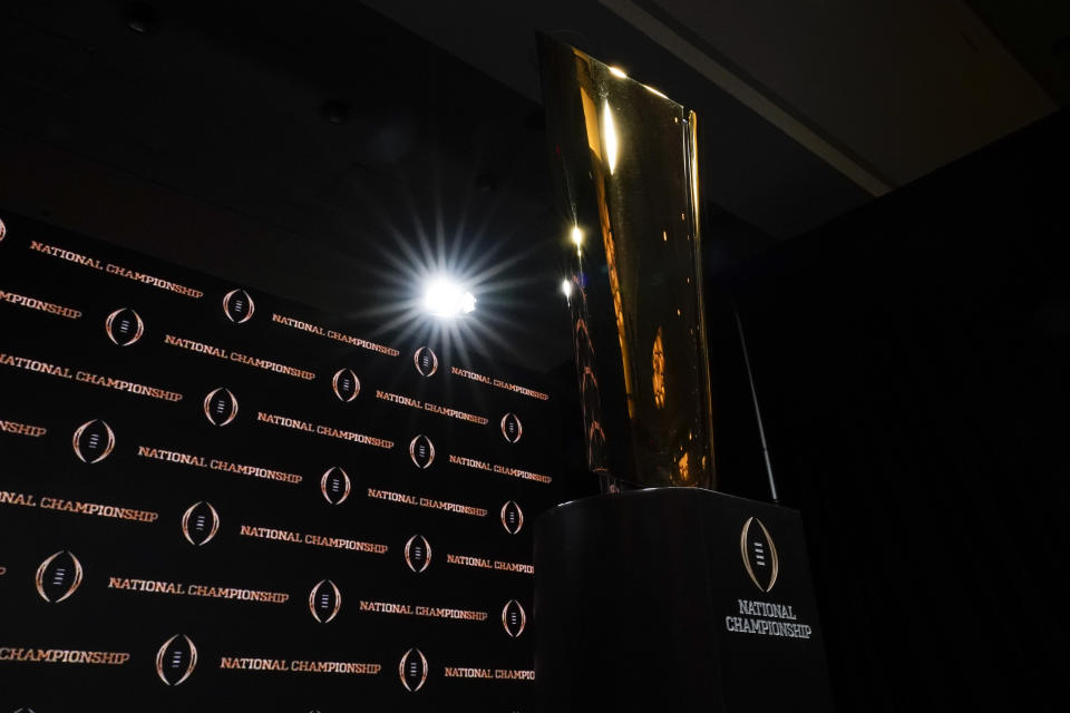 The trophy is displayed before a news conference for the NCAA College Football Playoff national championship game Sunday, Jan. 12, 2020, in New Orleans. Clemson is scheduled to play LSU on Monday. (AP Photo/David J. Phillip).