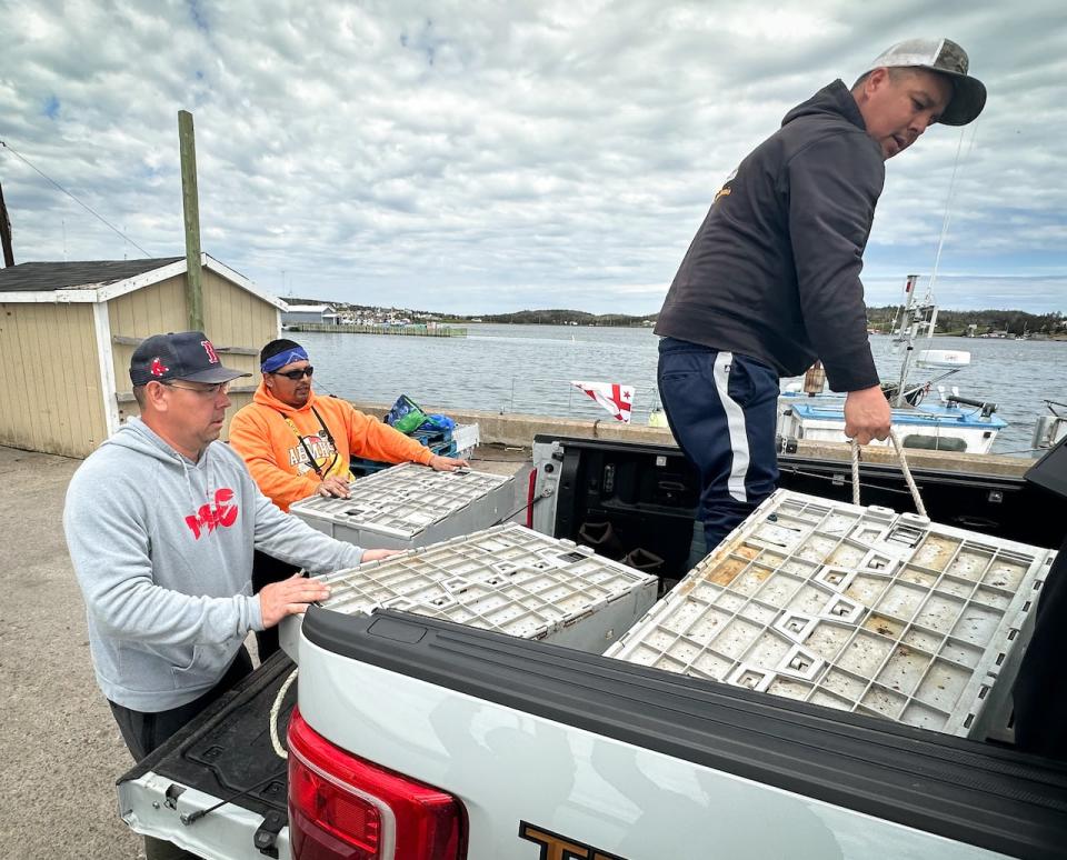 Charles Francis, left, says he and his crew are being denied their right to earn a moderate livelihood by non-Indigenous fishers who cut their traps and threatened their buyer.