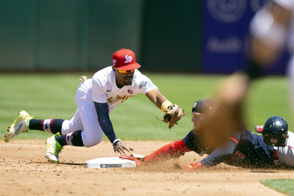 Boston Red Sox's Alex Verdugo, right, slides safely into second with a double ahead of a tag by Oakland Athletics second baseman Tony Kemp, left, during the third inning of a baseball game, Sunday, July 4, 2021, in Oakland, Calif. (AP Photo/D. Ross Cameron)