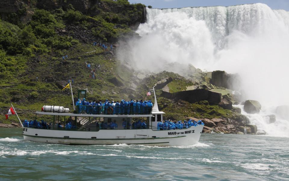 FILE - In this June 11, 2010 file photo, tourists ride the Maid of the Mist boat in Niagara Falls, N.Y. The tour company chosen to take over the Niagara Falls tour boat business in Canada says it plans to build customized new boats and upgrade amenities while maintaining the things that have made the sightseeing rides so popular for more than 100 years. (AP Photo/David Duprey, File)