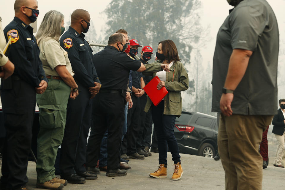 Democratic vice presidential candidate Sen. Kamala Harris, D-Calif., bumps elbows with first responders as she was briefed on the Creek Fire at Pine Ridge Elementary, Tuesday, Sept. 15, 2020 in Auberry, Calif. (AP Photo/Gary Kazanjian)