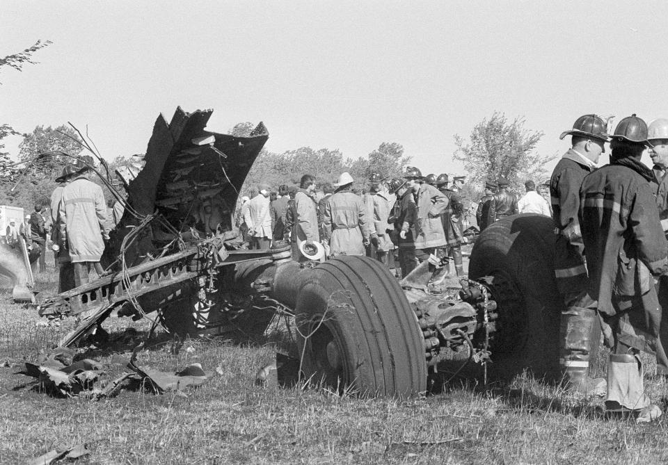 FILE - In this May 25, 1979 photo, a portion of the landing gear of an American Airlines DC-10 lies in foreground as firemen and emergency personnel survey wreckage scene northwest of O'Hare International Airport in Chicago. Decades later, the crash of American Airlines Flight 191 moments after it took off from Chicago's O'Hare International Airport remains the deadliest aviation accident in U.S. history. The DC-10 was destined for Los Angeles when it lost one of its engines May 25, 1979, killing what investigators later determined were 273 people _ all 271 people aboard the jetliner and two people on the ground. (AP Photo/Fred Jewell File)