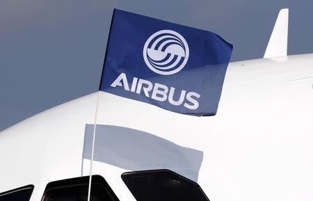 A flight test engineer holds an Airbus Group flag in Colomiers near Toulouse, southwestern France, September 25, 2014. REUTERS/Regis Duvignau