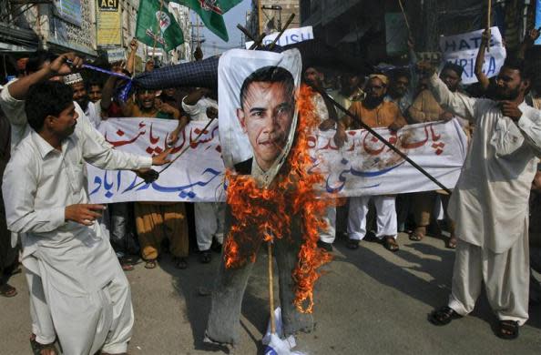 Supporters of the religious political party Sunni Tehreek set ablaze an effigy of U.S. President Barack Obama during an anti-American rally in Hyderabad September 27, 2011. Pakistan, facing a crisis in relations with the United States, appears to be seeking more support from powerful ally China. Washington accuses Pakistan's powerful ISI spy agency of directly backing the Afghan Taliban-allied Haqqani network and providing support for the Sept. 13 attack on the U.S. Kabul mission. Pakistan furiously rejected the allegations and warned the United States that it risked losing an ally if it kept publicly criticizing Pakistan over the militant groups. The banner in the background reads, 'Long Live Pakistan's Army.'