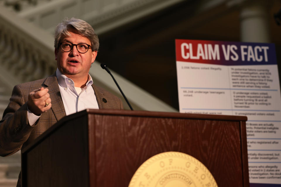 Gabriel Sterling stands at a podium in front of a poster titled: Claim vs Fact.