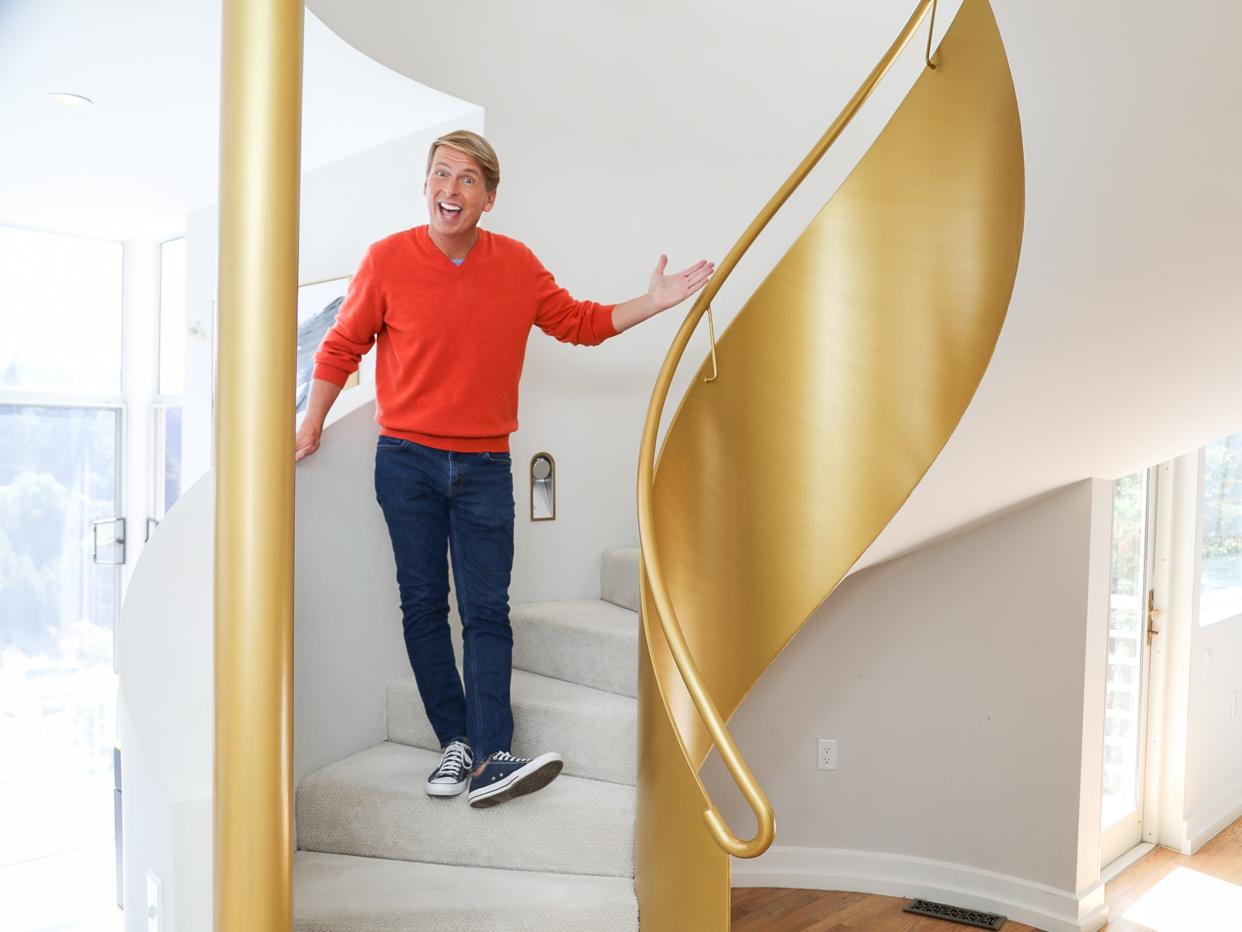 Jack McBrayer next to a gold staircase in "Zillow Gone Wild"