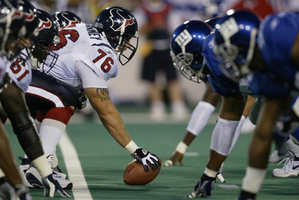 The Houston Texans and the New York Giants are pictured at the line of scrimmage during the AFC-NFC Hall of Fame Game at Fawcett Stadium on Aug. 5, 2002 in Canton.