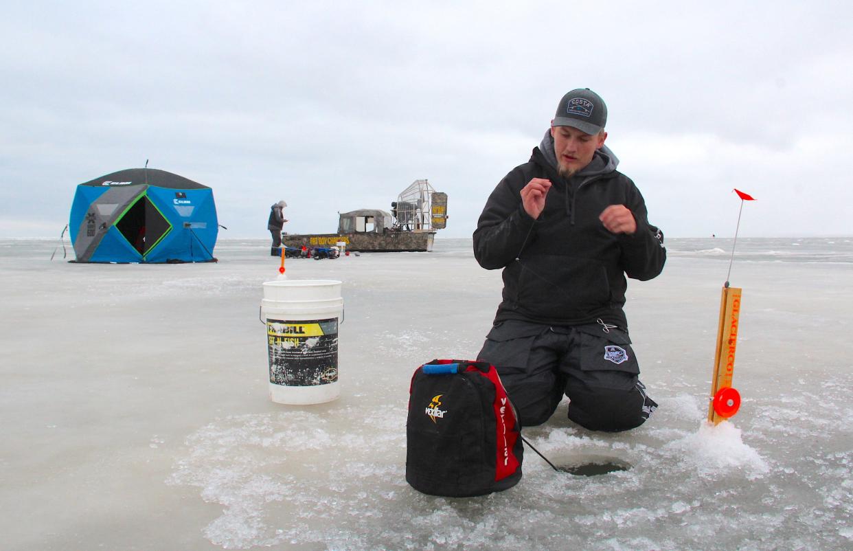 Brody Alexander of Ice Fish Green Bay sets a tip down during a Jan. 28 outing on Green Bay. The group accessed the spot with an airboat.