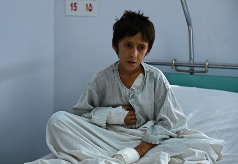 A wounded Afghan boy, survivor of the US airstrikes on the MSF Hospital in Kunduz, sits on his bed at a hospital in Kabul on October 6, 2015