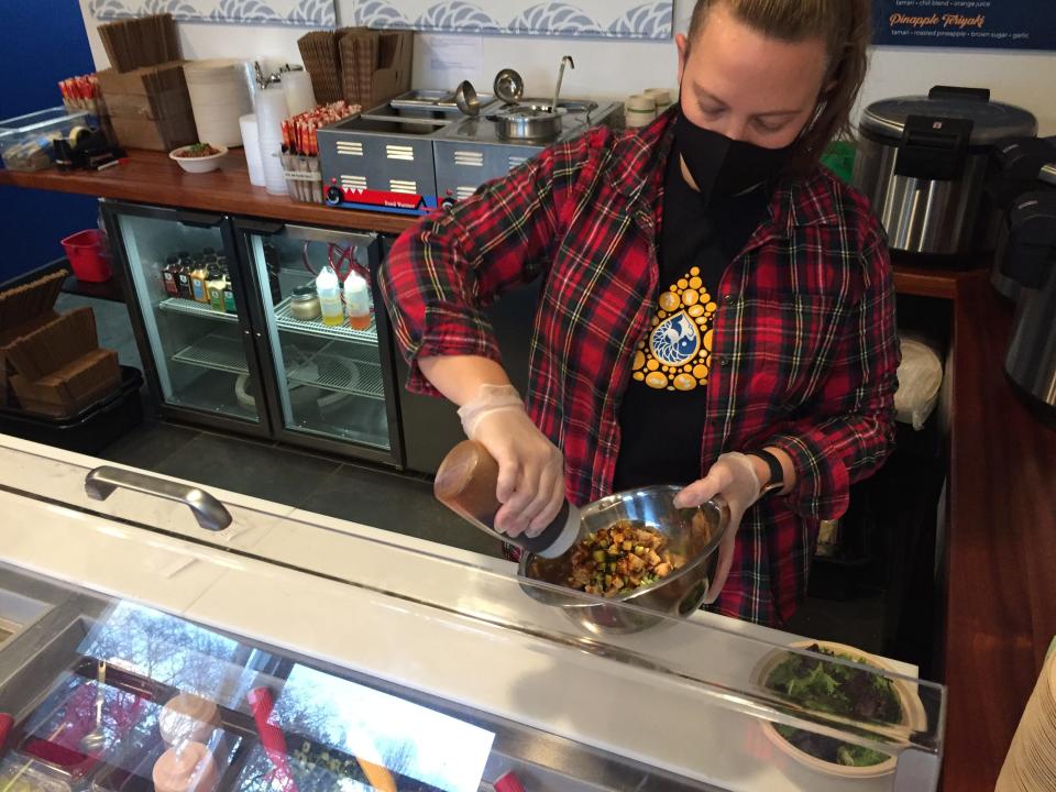 Perry Farr, co-owner of The Scale poke bar, prepares a poke bowl at the Essex Junction site Dec. 4, 2020.
