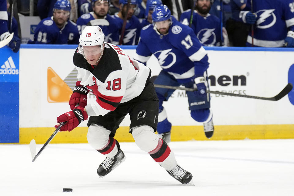 New Jersey Devils left wing Ondrej Palat (18) moves the puck ahead of Tampa Bay Lightning left wing Alex Killorn (17) during the first period of an NHL hockey game Sunday, March 19, 2023, in Tampa, Fla. (AP Photo/Chris O'Meara)