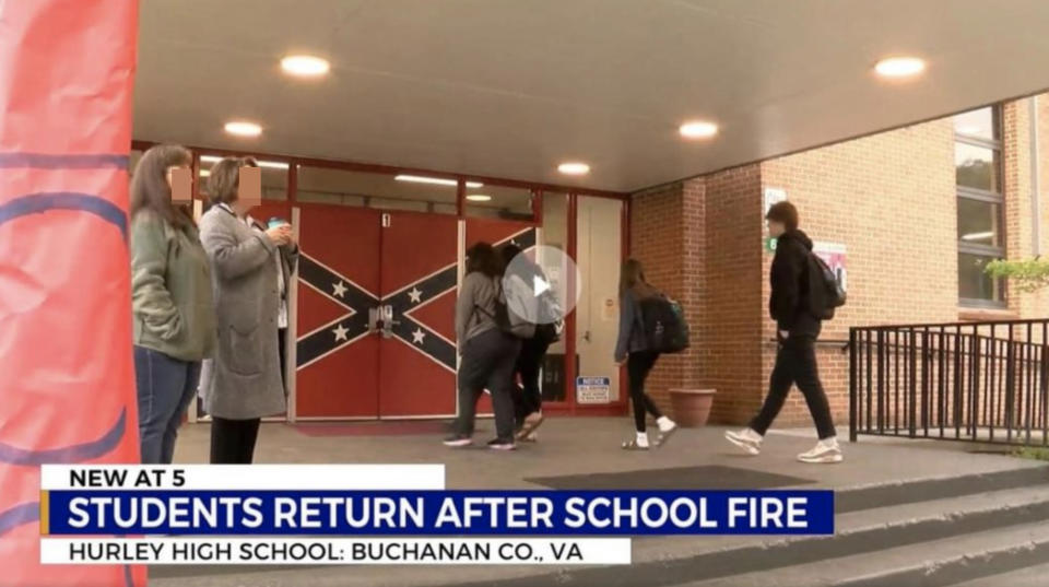 students walking with the flag on the doors